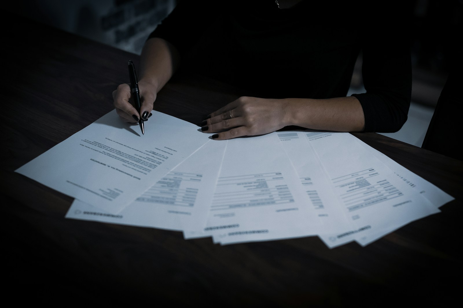 Business owner poring over financial paperwork spread across a desk