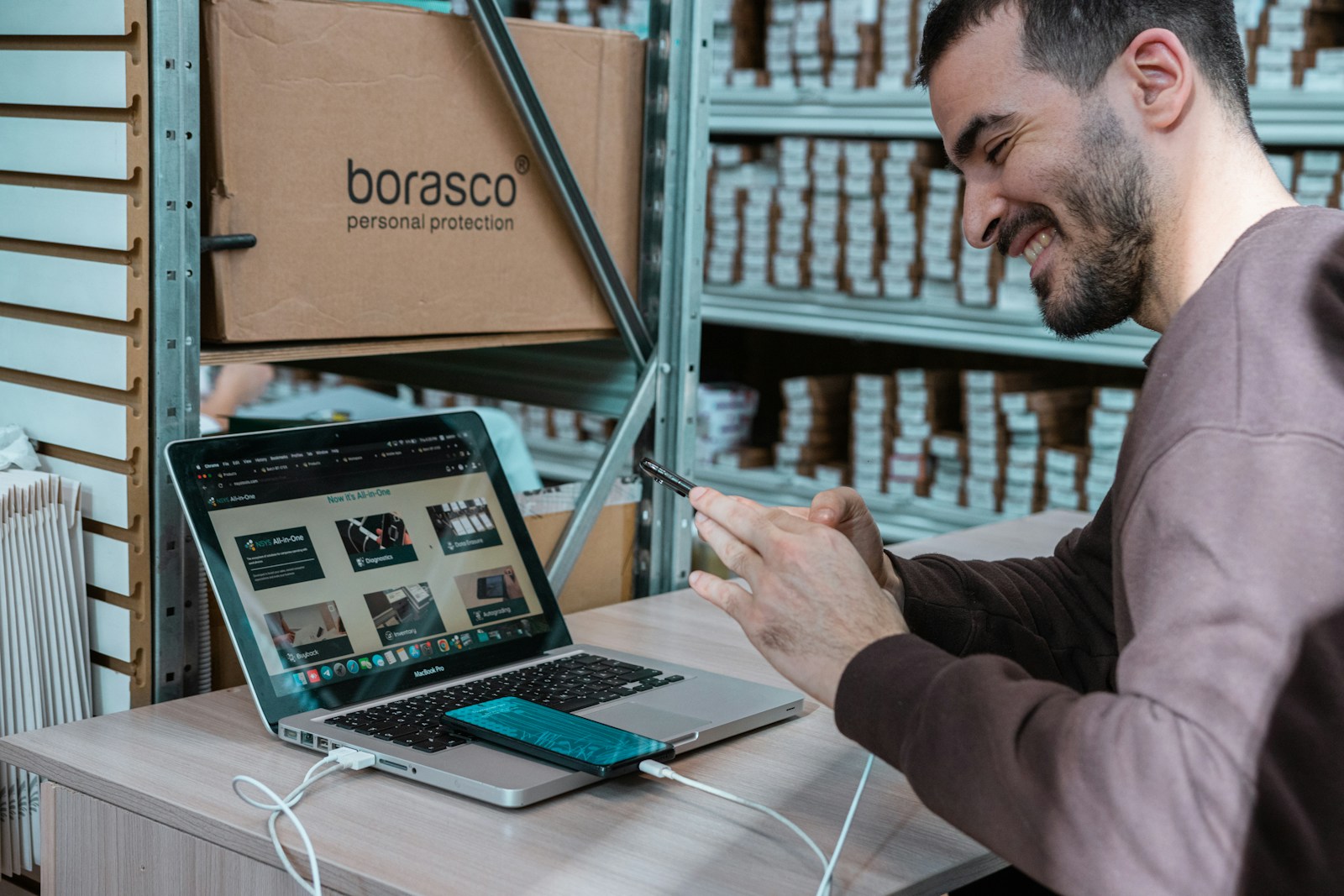 eCommerce business owner working on a laptop in his stockroom